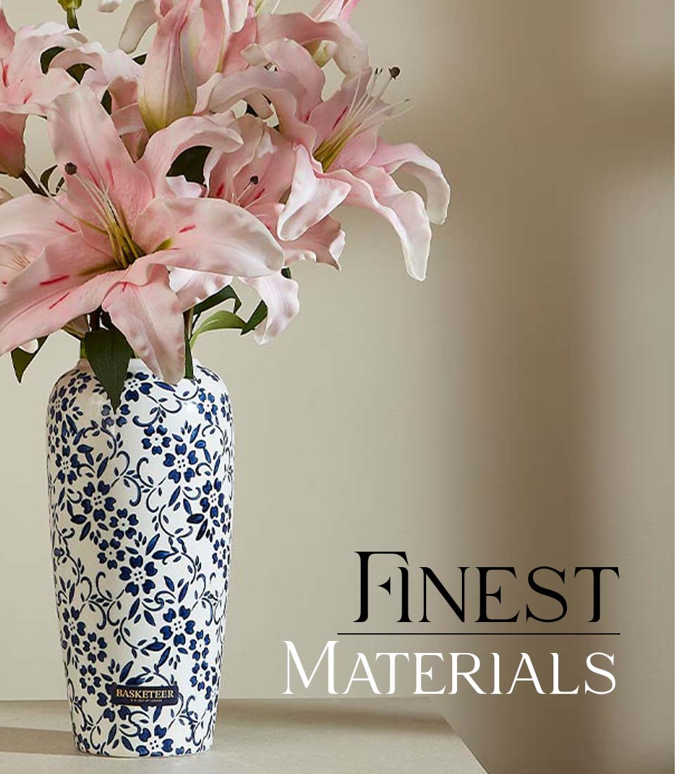 Tall ceramic vase with blue floral pattern holding light pink lilies, premium artificial flower arrangement