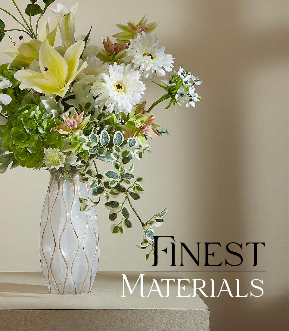 Serene Meadow Bloom artificial flower arrangement with yellow lilies, white daisies, and green hydrangeas in frosted glass
