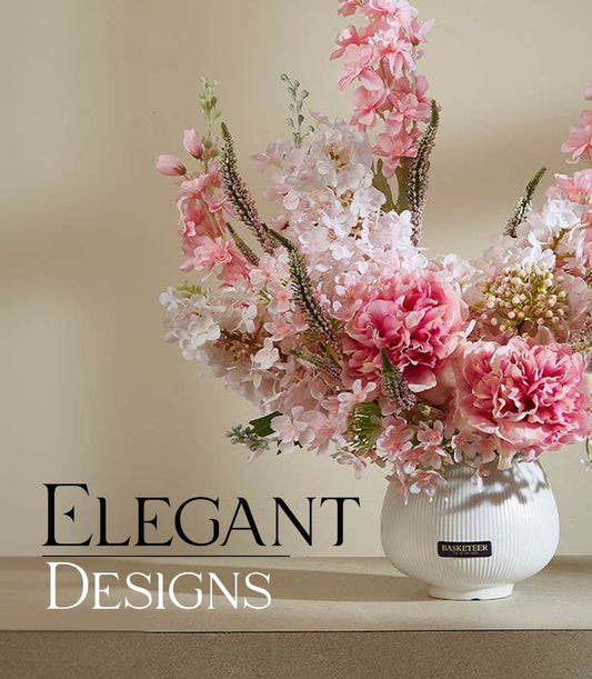 Elegant pink and white artificial peonies in ribbed white ceramic vase with greenery accents
