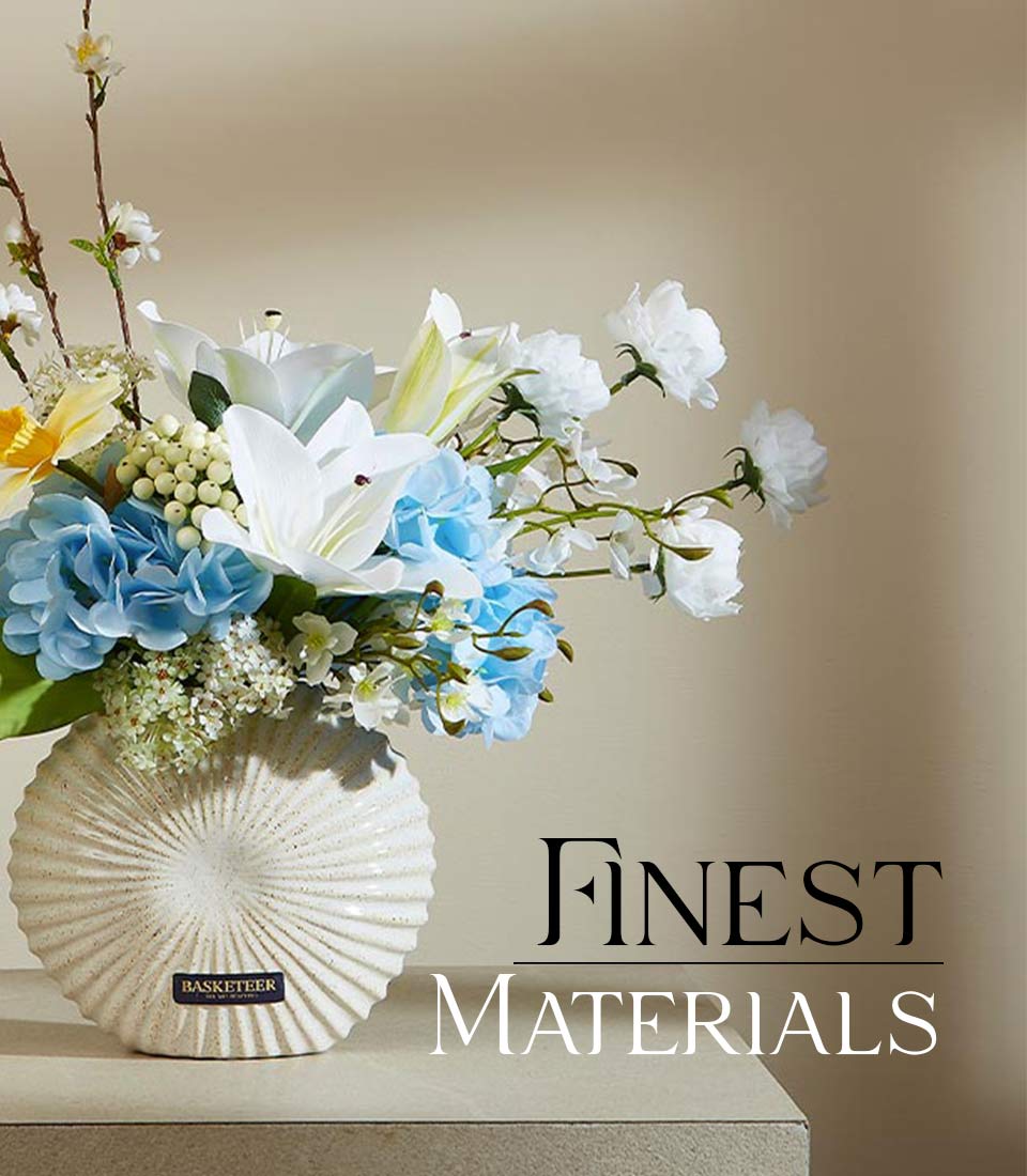 White lilies and light blue hydrangeas in textured ceramic vase, spring floral gift arrangement