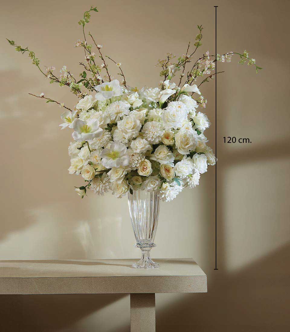 Pristine white artificial flower arrangement with roses and dahlias in tall fluted glass vase, 120 cm height