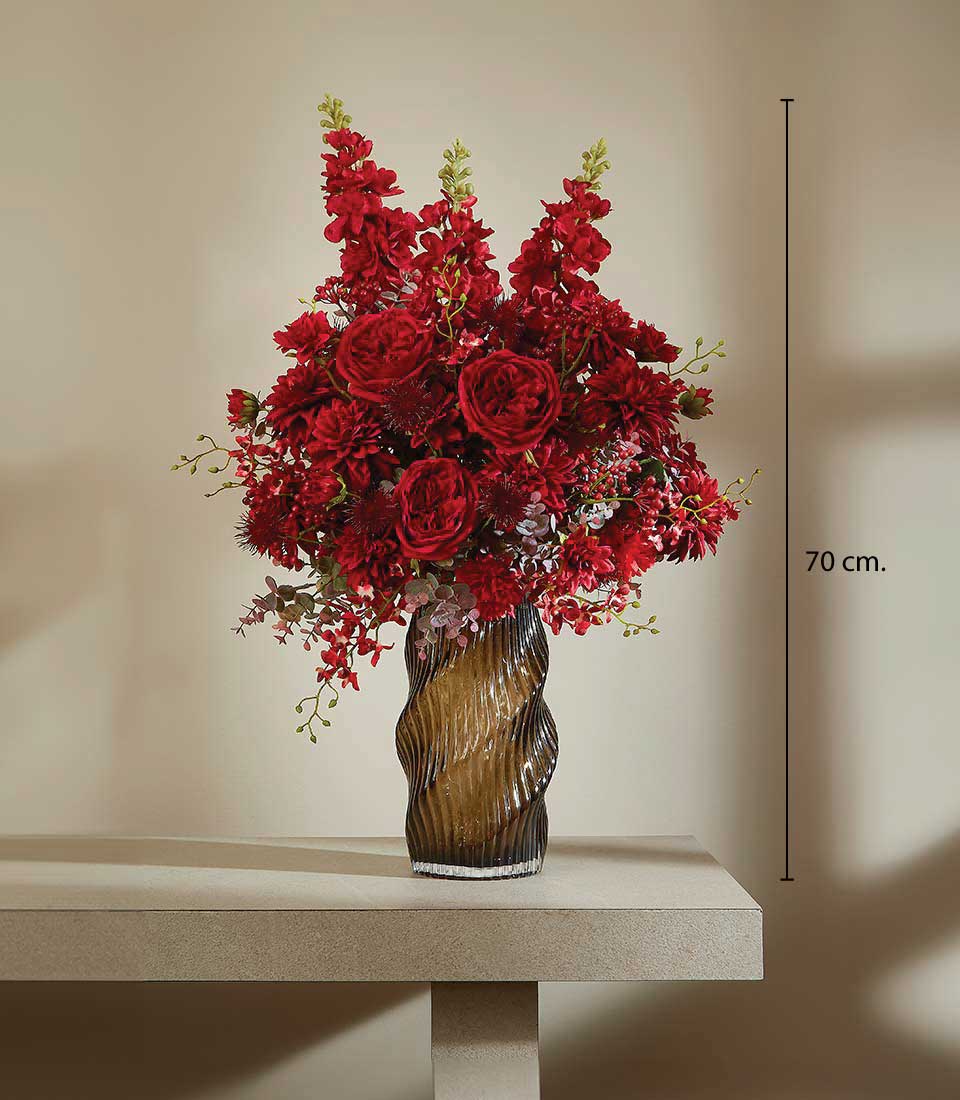 Graceful red artificial flower arrangement in amber glass vase, tall luxury blooms for gifting