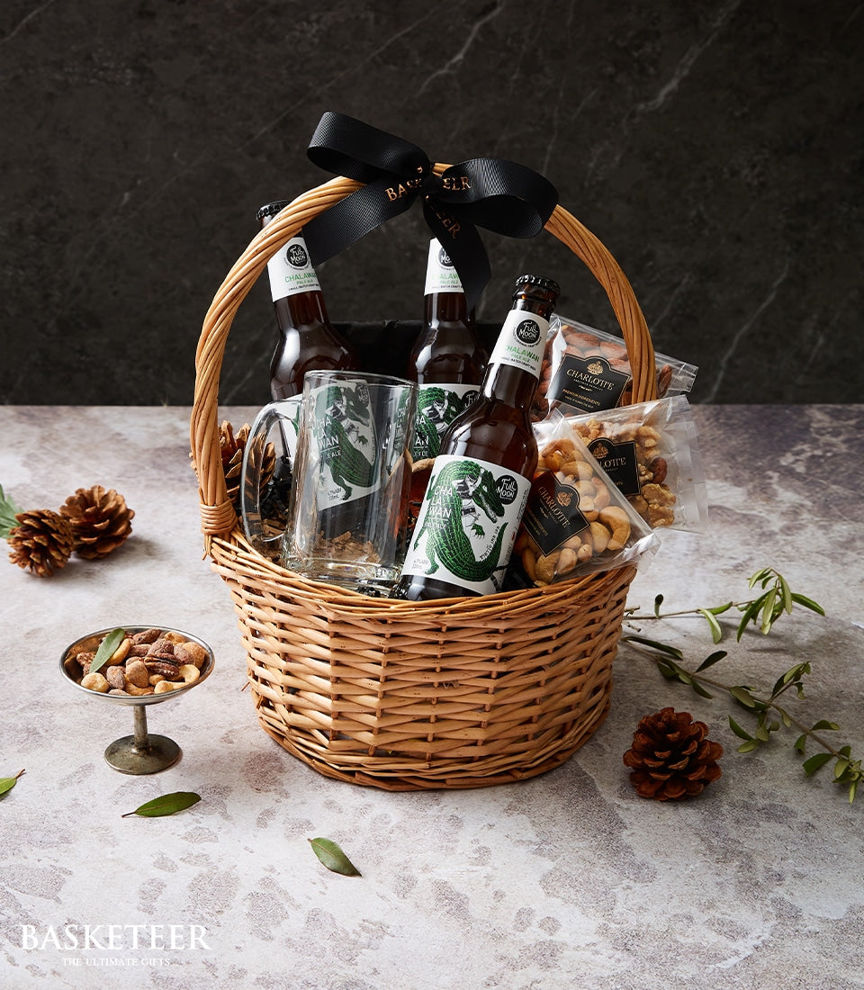 Premium beer and nut gift basket with Chalawan pale ale, craft mugs, and artisan snacks in wicker