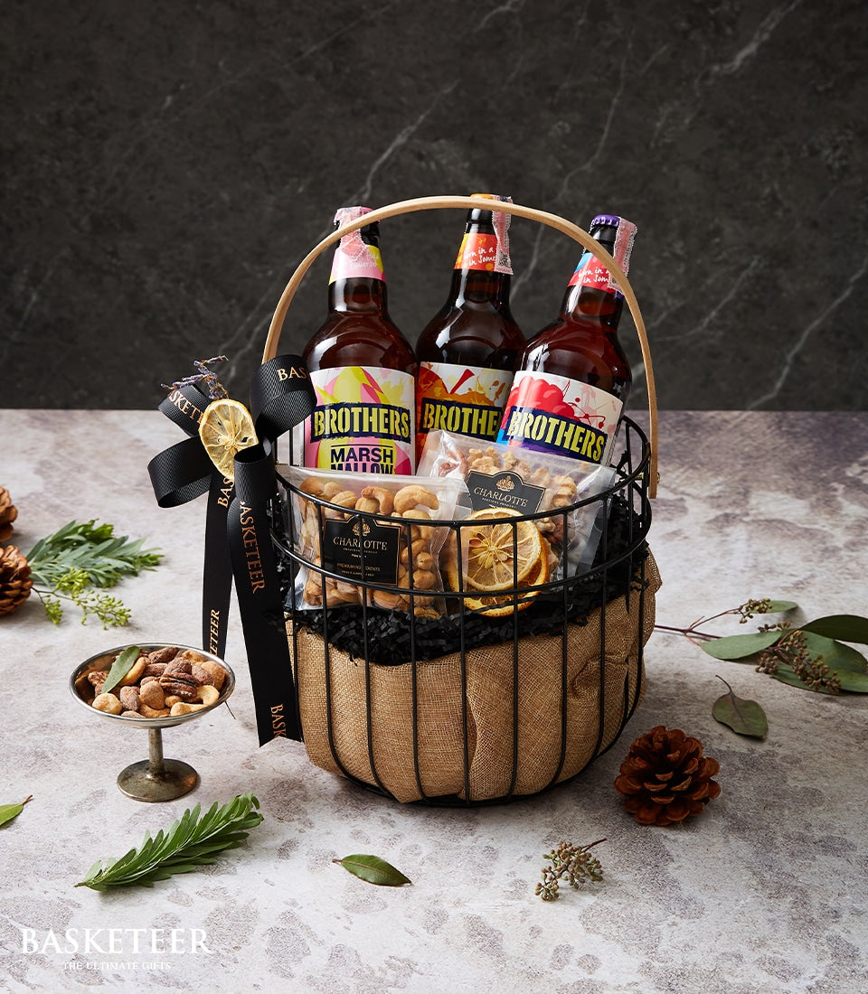 Premium cider and gourmet nut gift basket with Brothers beverages, roasted nuts, and dried fruit in burlap-lined wire basket