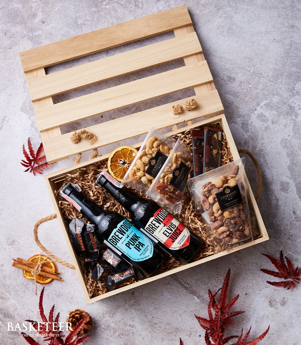 Wooden craft beer crate with BrewDog IPA, gourmet nuts, chocolates, and festive spices