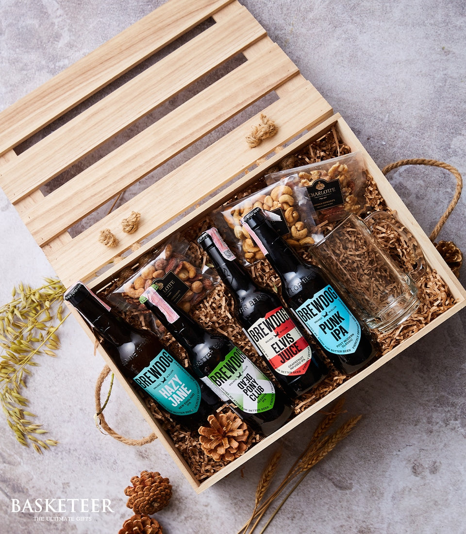 Premium BrewDog craft beer crate with four varieties, nuts, and glass mug in rustic wooden gift box