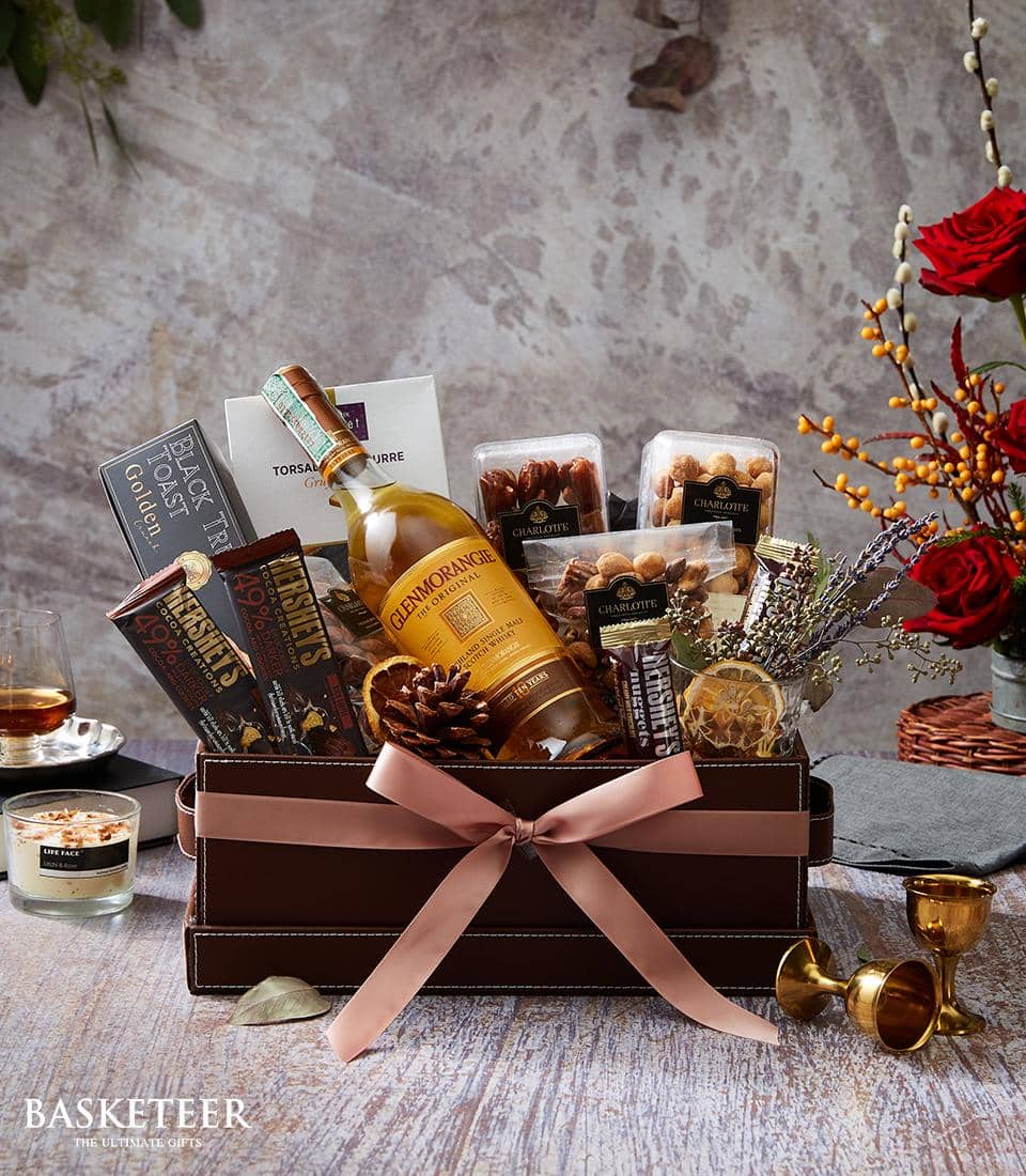 Premium whisky gift hamper with Glenmorangie, dark chocolate, nuts, and dried fruits in faux leather box with pink ribbon