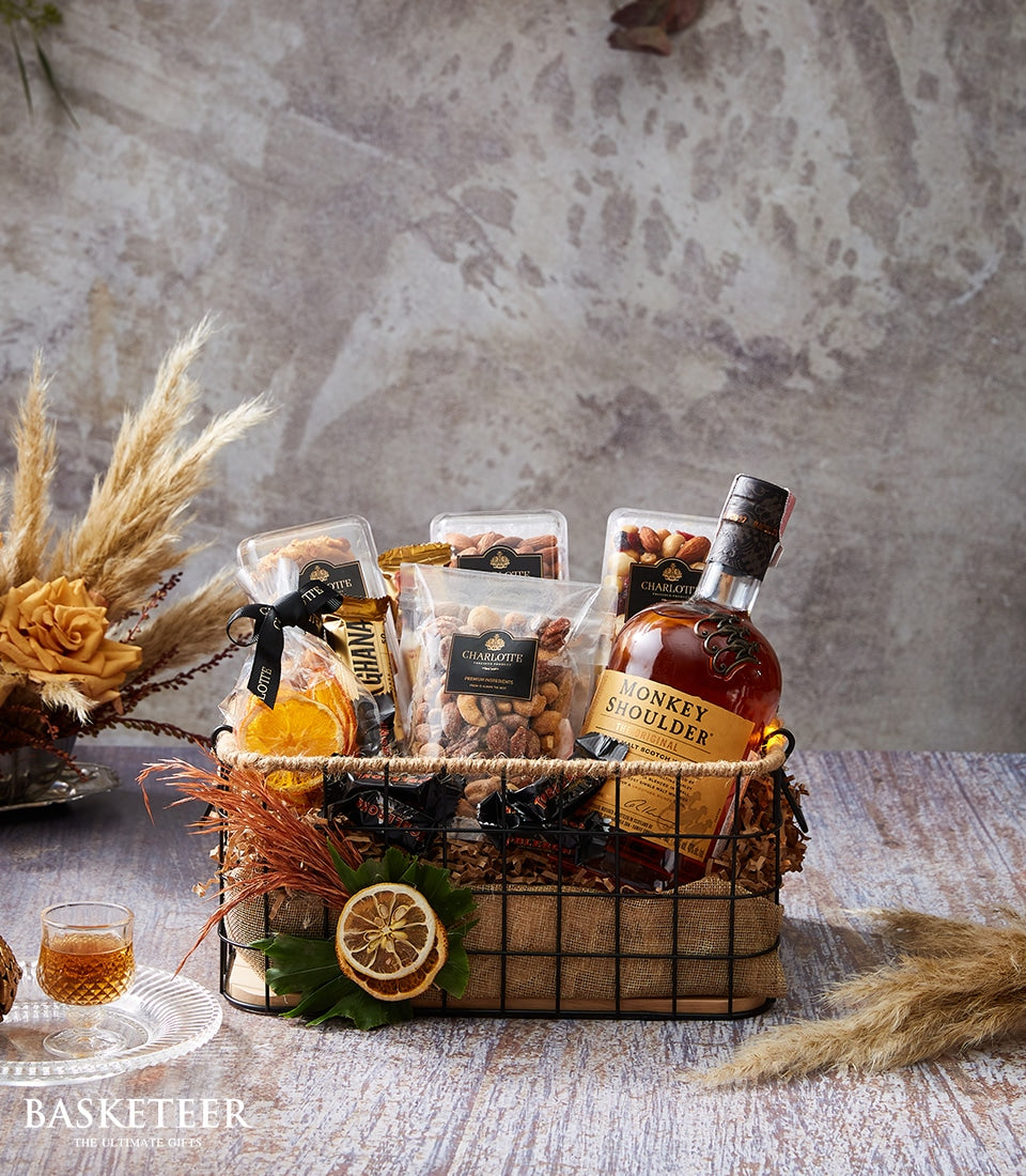 Monkey Shoulder blended malt scotch whisky gift basket with nuts, dried fruit, chocolate, and orange roses