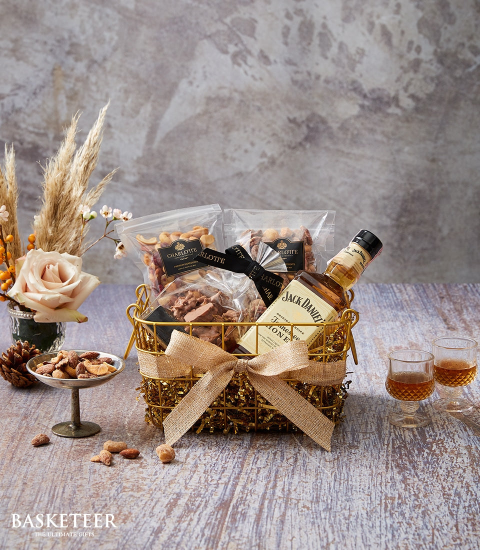 Premium whiskey and gourmet snacks gift basket with Jack Daniel's, nuts, and chocolate clusters