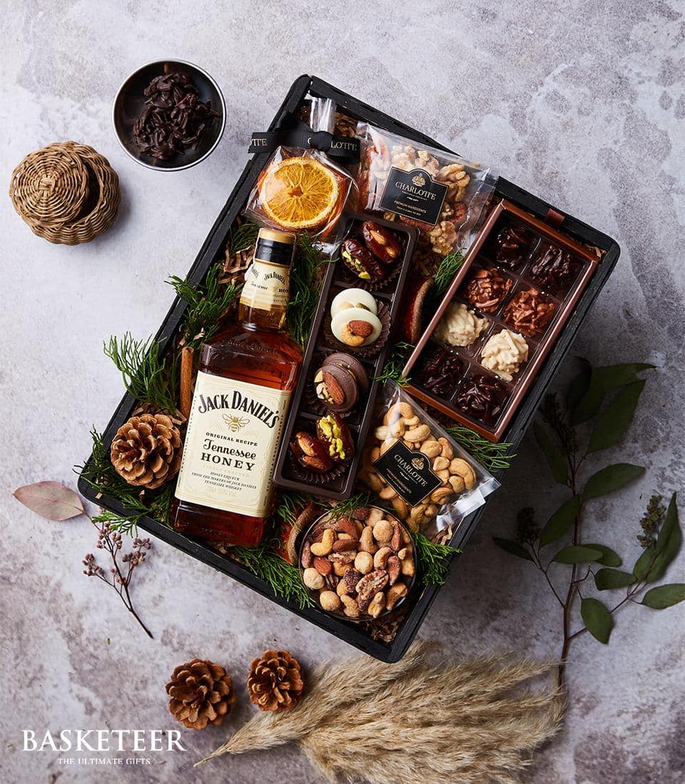 Premium whiskey gift hamper with Jack Daniel's, gourmet chocolates, nuts, and dried fruit
