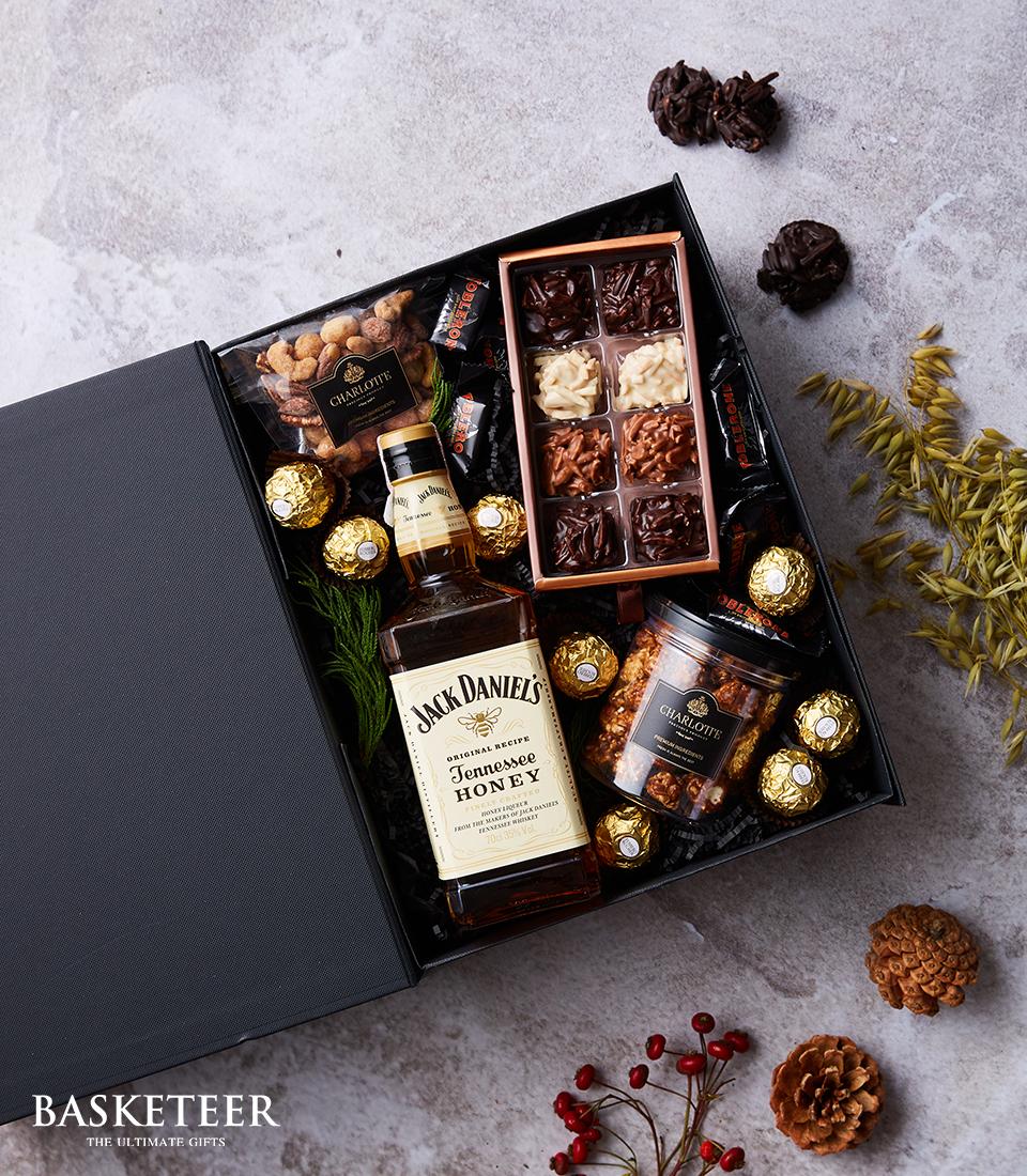 Luxury whisky gift box with Jack Daniel's Tennessee Honey, gourmet chocolates, nuts, and caramel popcorn