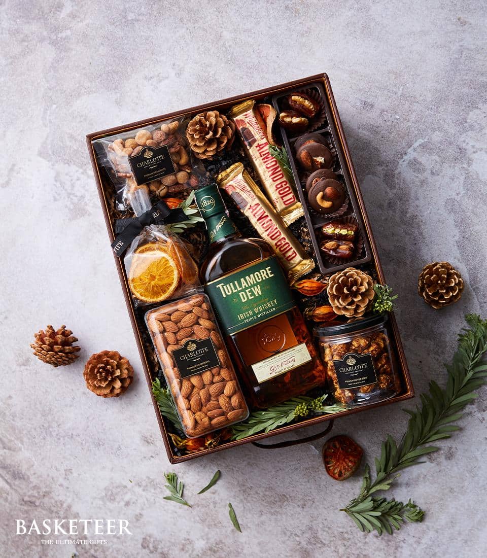 Premium Irish whiskey gift box with gourmet chocolate, nuts, and dried fruits in artisan presentation