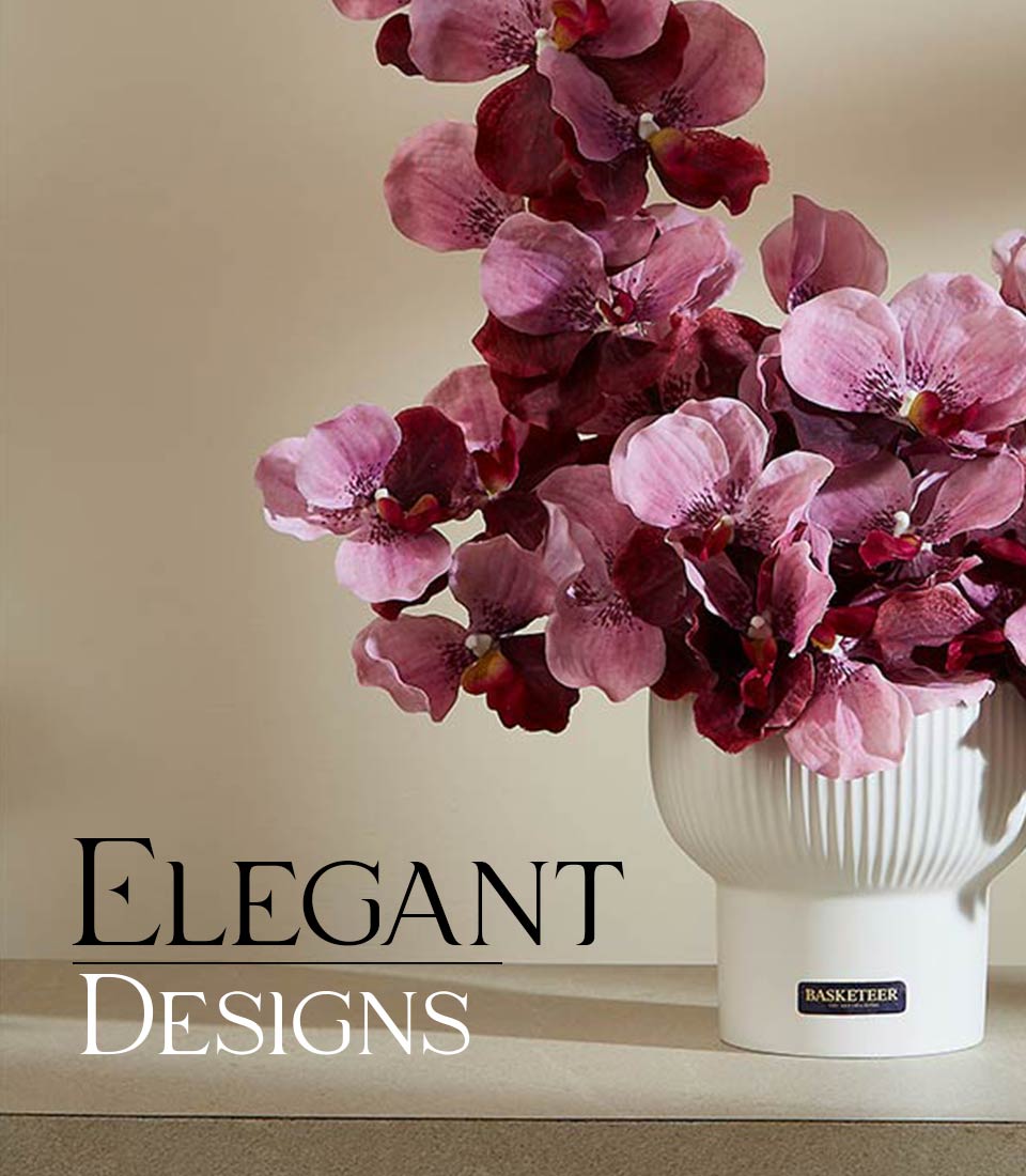 Elegant artificial orchid arrangement in pink and maroon with ribbed white ceramic vase