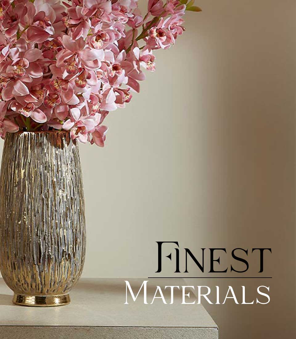 Tall distressed gold vase with soft pink orchid flower arrangement for elegant home décor