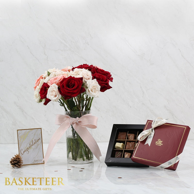 Luxury flower and chocolate gift set with red roses in glass vase and artisan chocolates