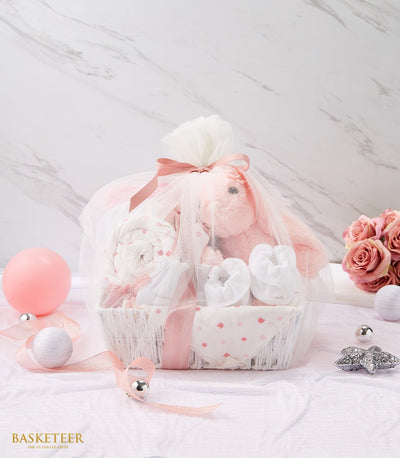 Tender Newborn Baby Love Gift Ensemble with pink bunny, booties, and polka-dot blanket in white woven basket
