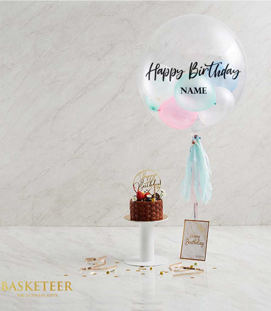 Birthday chocolate cake with fresh berries and pastel balloon gift set, gold cake topper and tassel garland