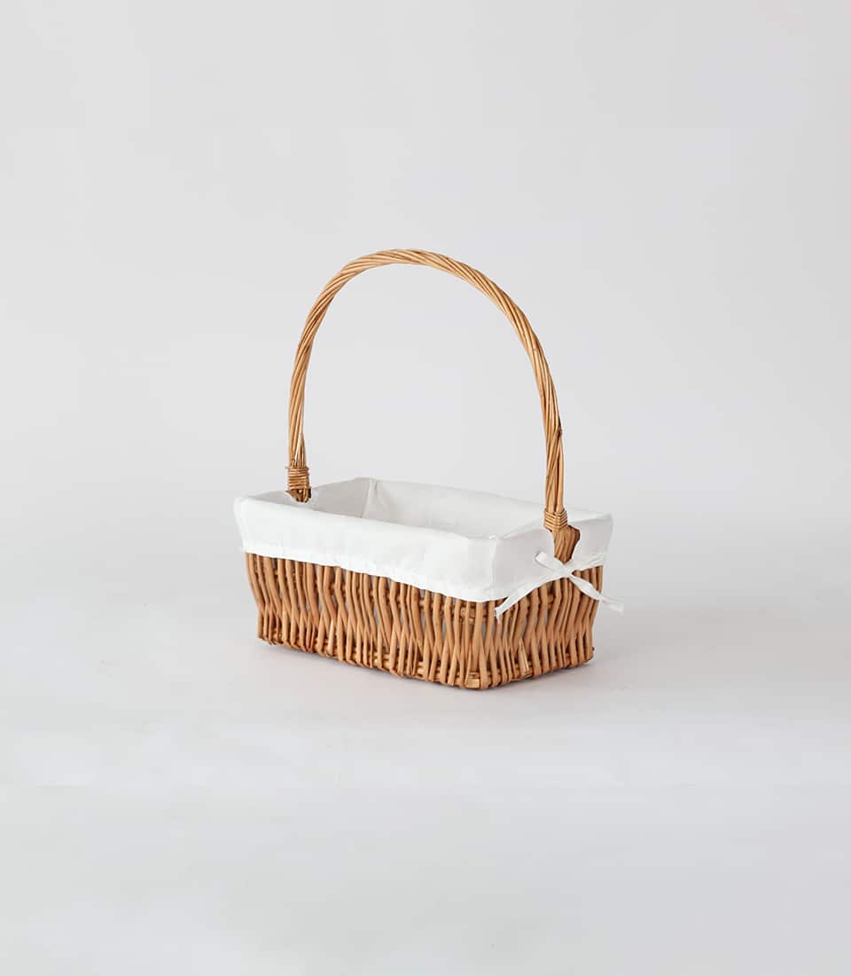 Light brown woven storage basket with cloth lining and arched handle for luxury gift hampers