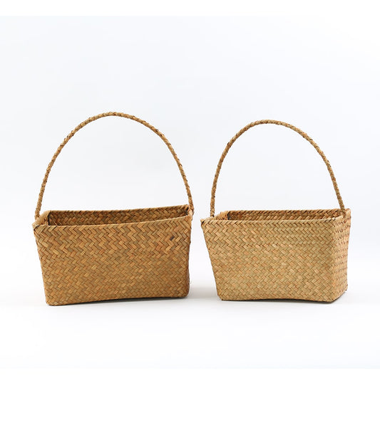 Natural woven straw gift baskets with handles in two sizes for luxury hamper presentation