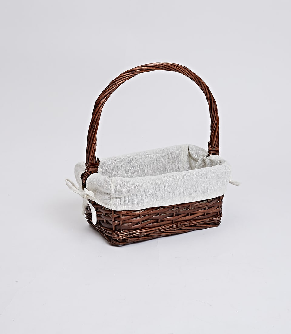 Dark brown wicker gift basket with cream fabric liner and bow, ready for custom curation