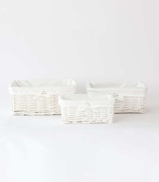 White wicker gift baskets with removable fabric liners in three sizes
