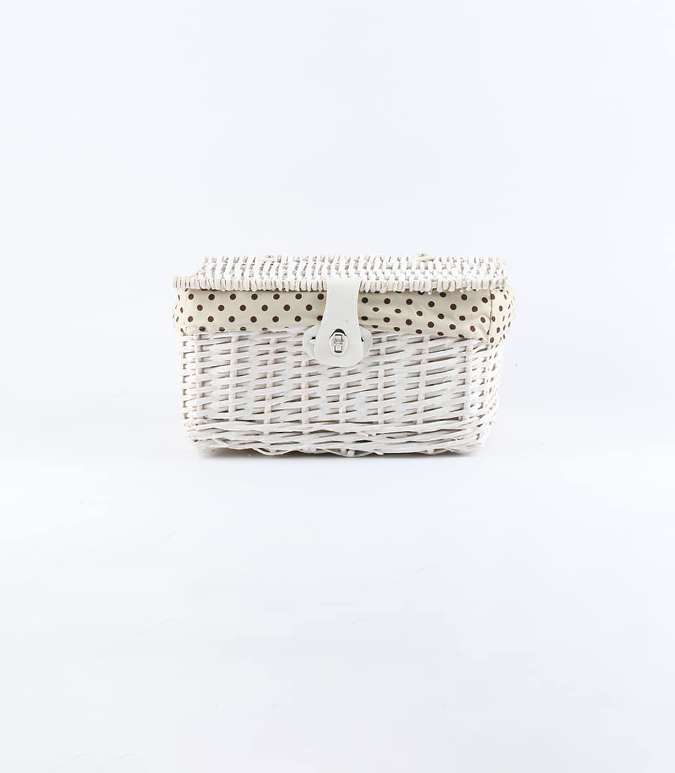 White wicker gift basket with polka-dot lined lid and silver clasp