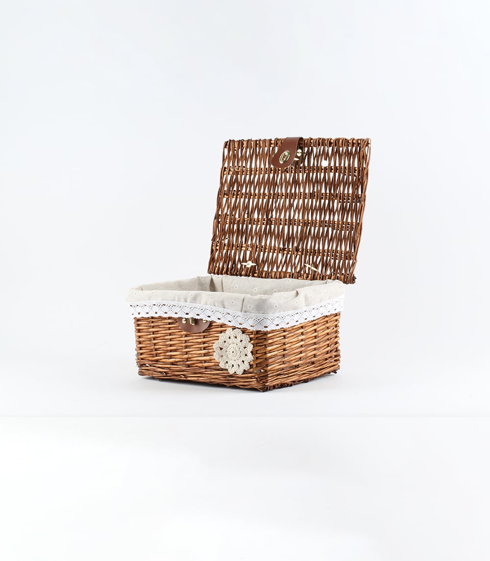 Dark brown wicker gift basket with hinged lid, beige fabric lining, and gold buckle closure