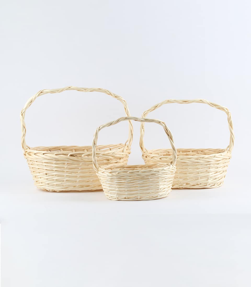 Natural wicker baskets in three sizes with twisted handles, light beige woven craft for gift hamper customization
