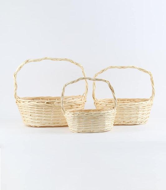 Natural wicker baskets in three sizes with twisted handles, light beige woven craft for gift hamper customization