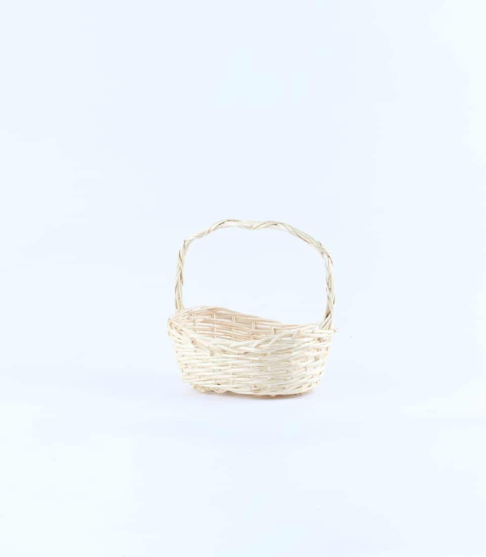 Woven light beige wicker basket with arched handle for luxury gift presentation