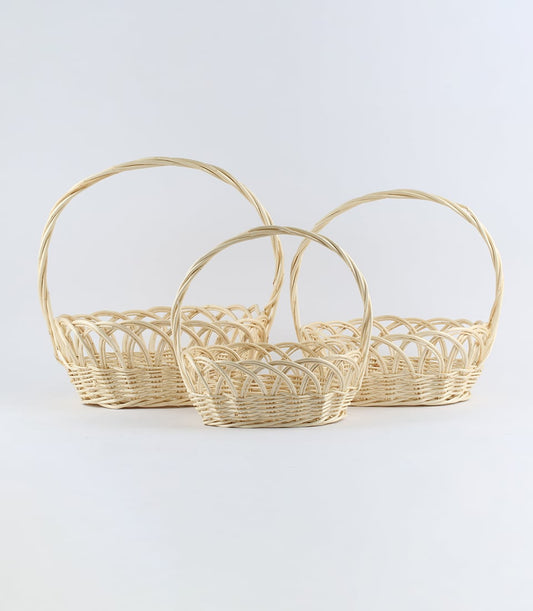 Natural wicker baskets in three sizes with twisted handles, ideal for luxury gift hampers and artisan packaging