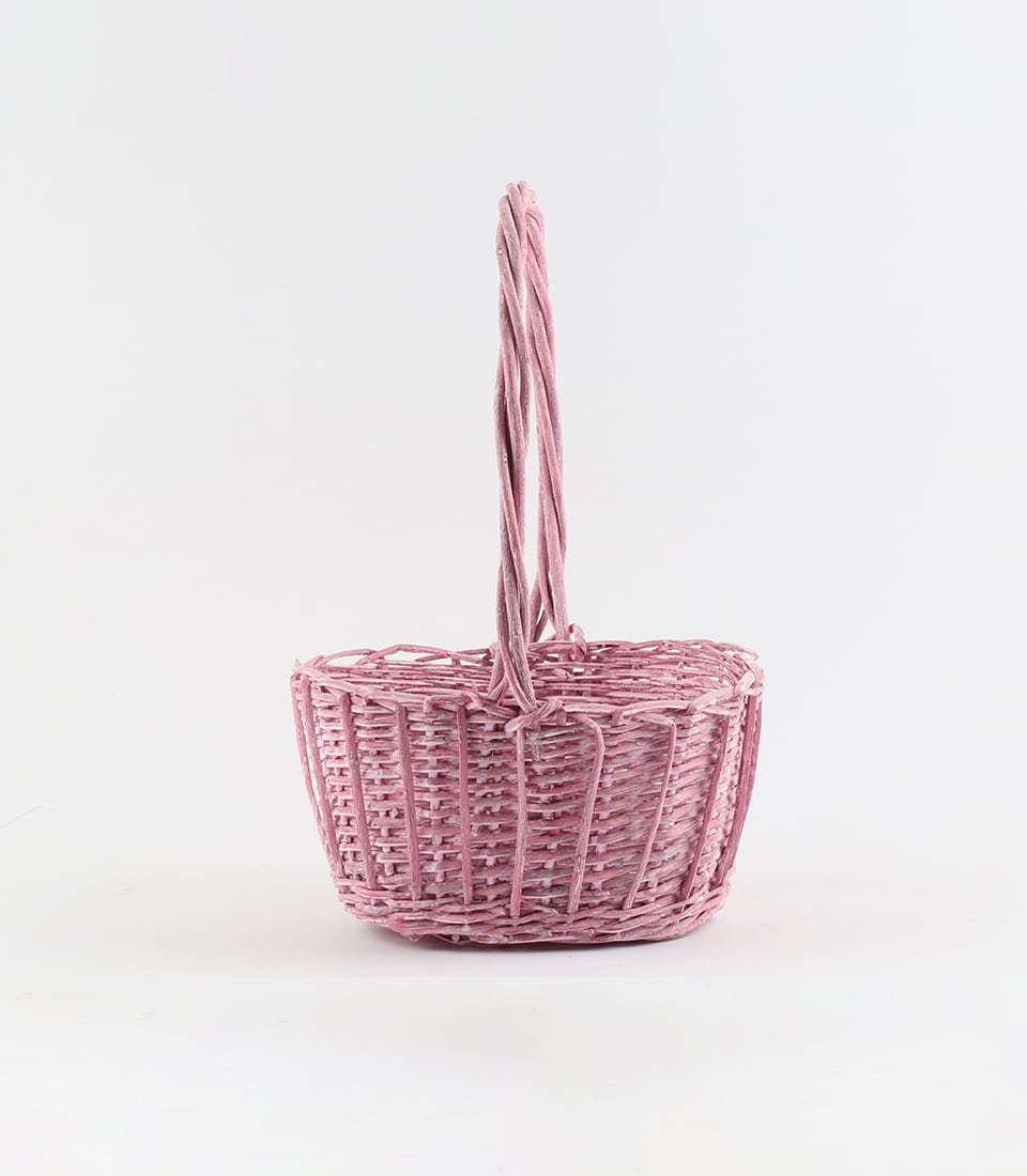 Blush pink woven wicker basket with curved handle, artisan gift container