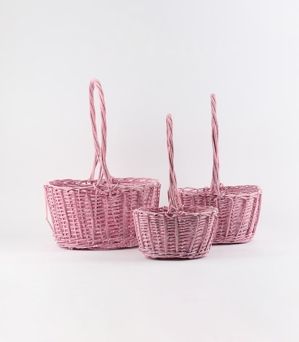 Pink rattan baskets with twisted handles in three sizes, artisan woven gift storage