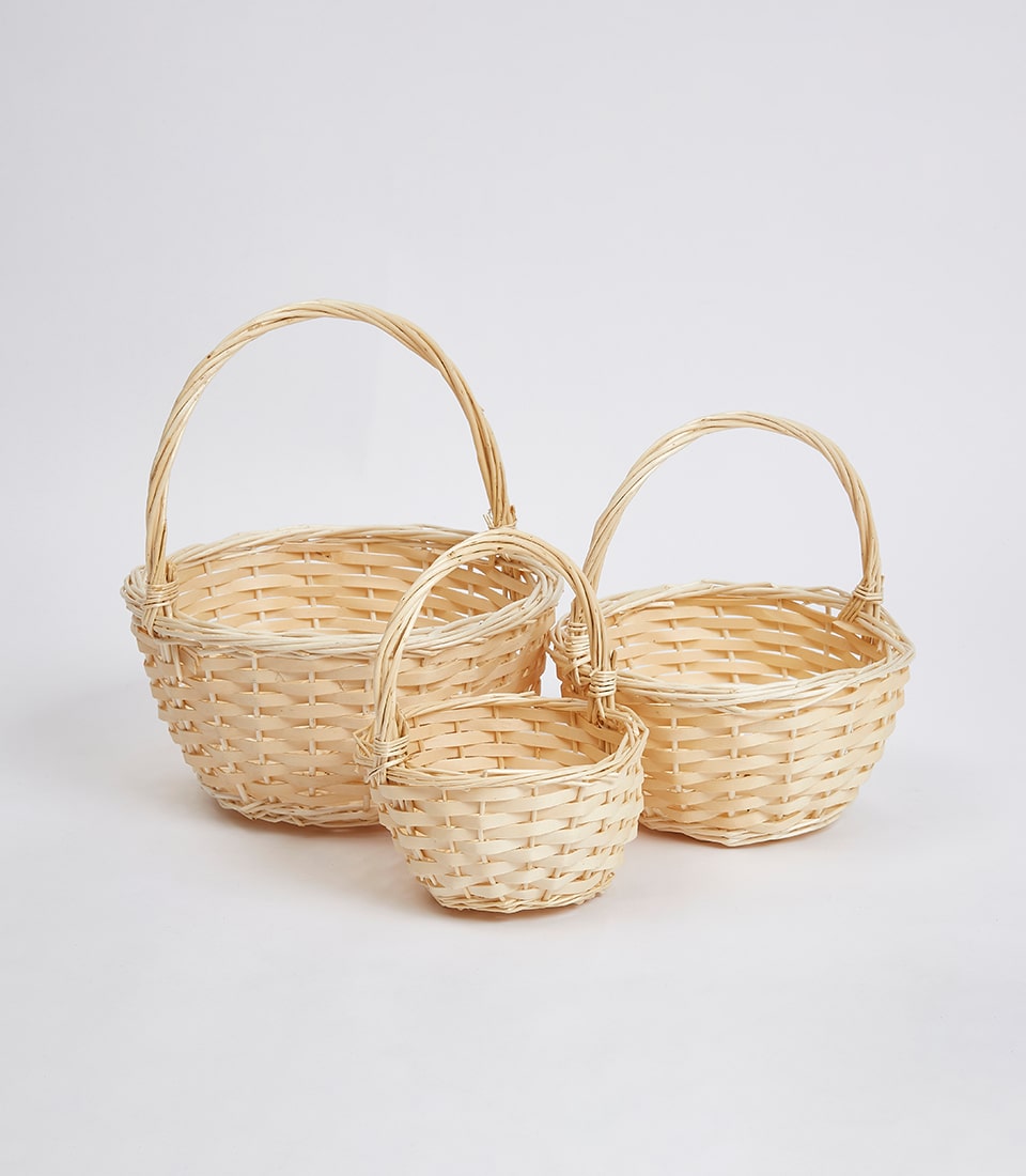 Natural wicker baskets in three sizes with twisted handles for luxury gift hampers