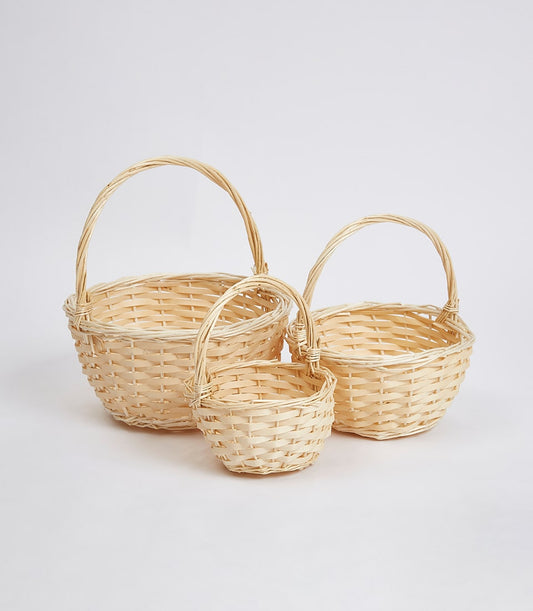 Natural wicker baskets in three sizes with twisted handles for luxury gift hampers