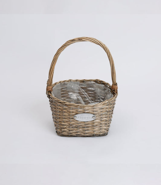 Light brown wicker basket with arched handle, ready for fresh flowers or plants
