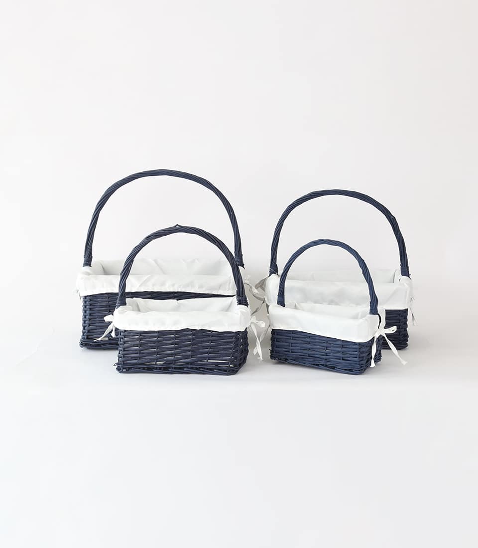 Navy rattan gift baskets with white fabric liners and arched handles, four-piece set