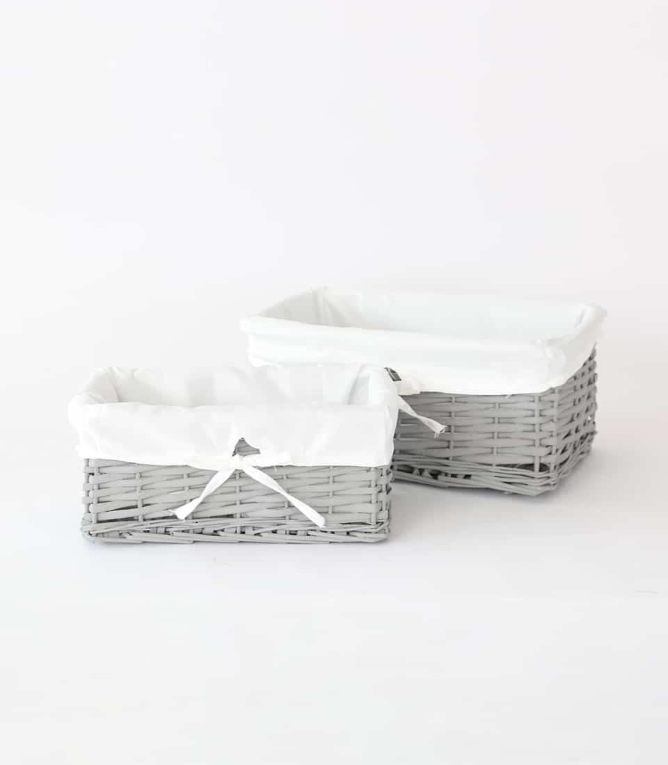 Gray wicker gift baskets with white fabric liners, ideal for luxury hamper presentation
