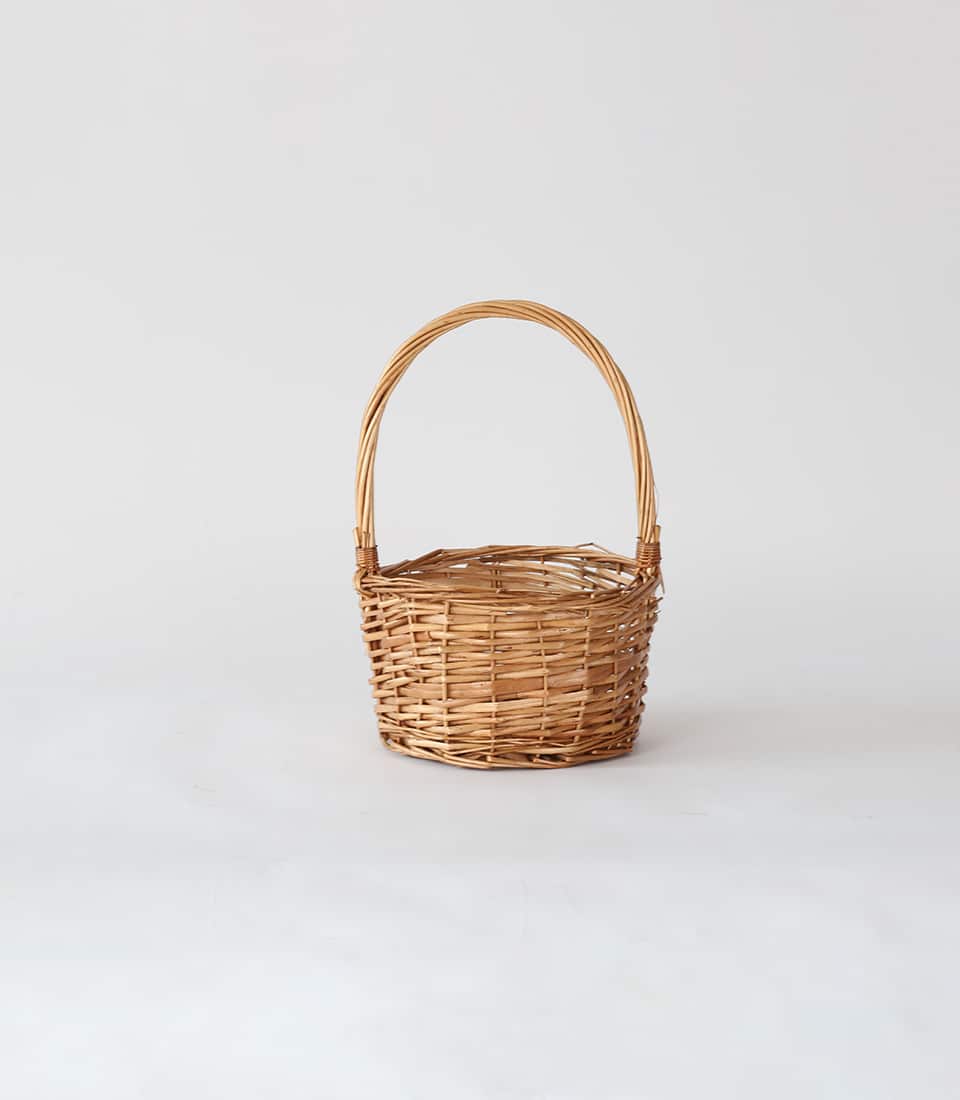 Light brown woven wicker hamper with handle, traditional artisan basket for premium gift presentation