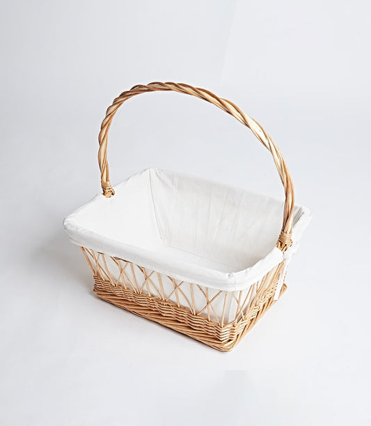 Natural wicker gift basket with arched handle and removable white fabric liner