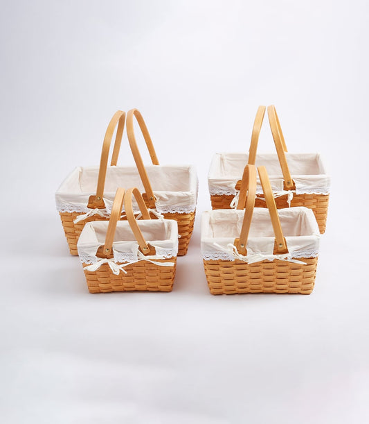 Tiered set of four light brown woven gift baskets with fabric liners and wooden handles