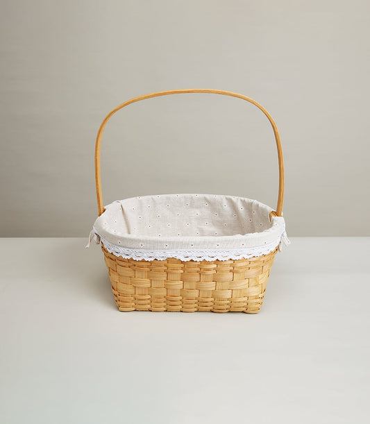 Woven rattan gift basket with beige linen lining and lace trim