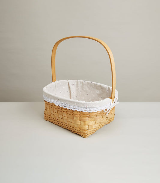 Natural woven rattan basket with cream cloth lining, lace trim, and wooden handle