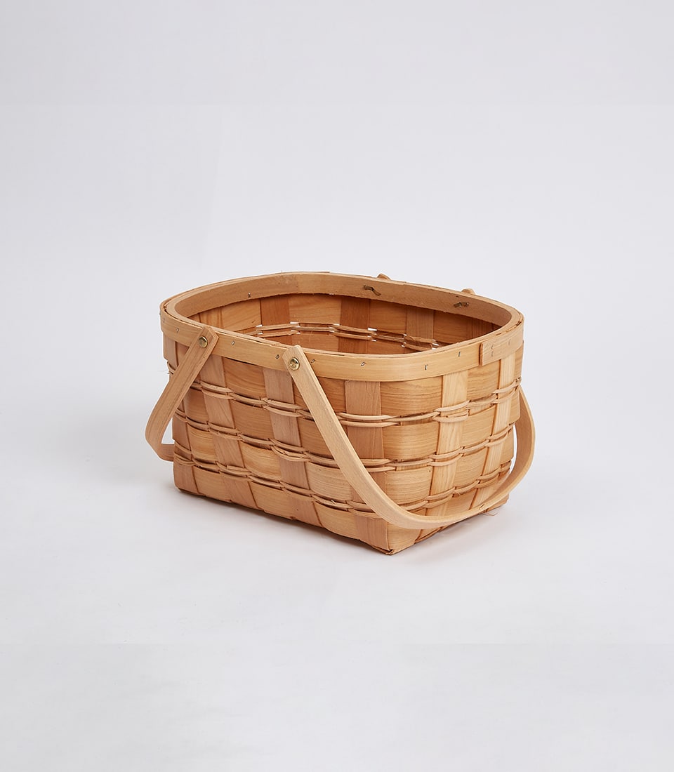 Woven wicker hamper basket with wooden handles, natural tan finish