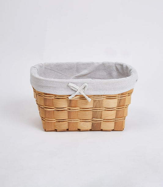 Natural woven wooden basket with light grey linen interior and delicate bow detail