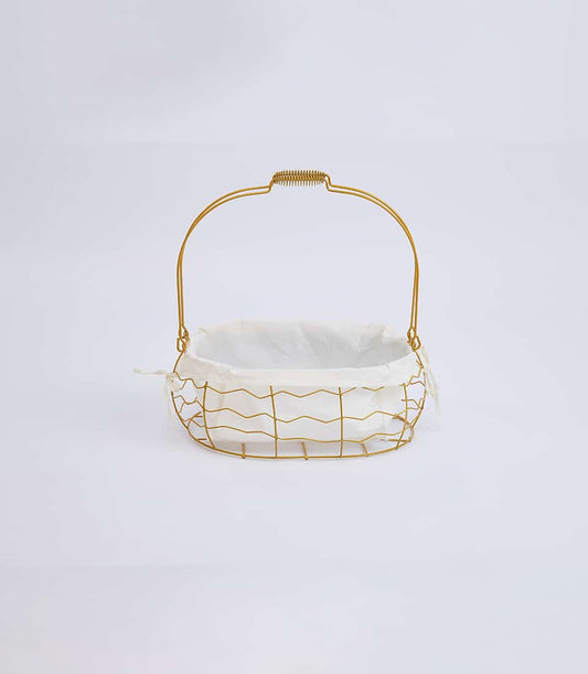Gold-framed oval basket with white linen liner and curved handle for gifting