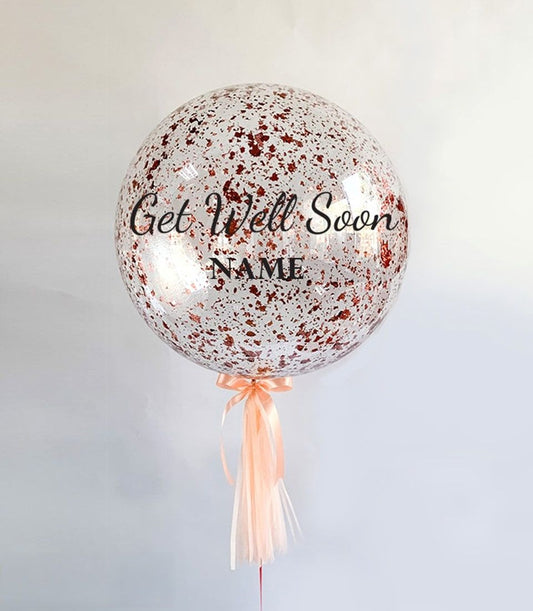 Rose gold confetti balloon with Get Well Soon personalised message and peach satin ribbon tassel