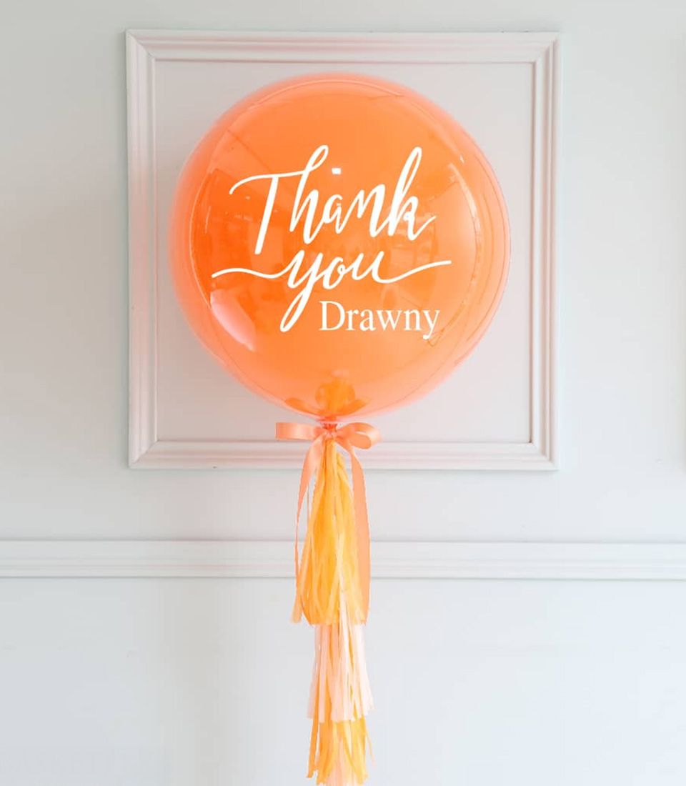 Personalised orange thank you balloon with peach satin ribbon and tissue paper tassel garland