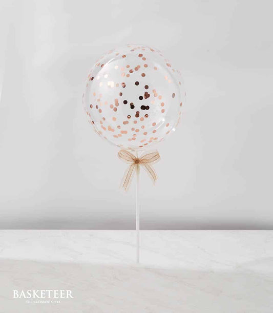Rose gold confetti balloon on white stick with sheer ribbon bow