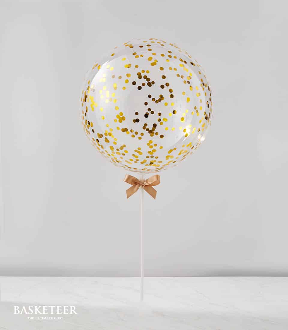 Gold confetti balloon with ribbon bow on stick for celebrations